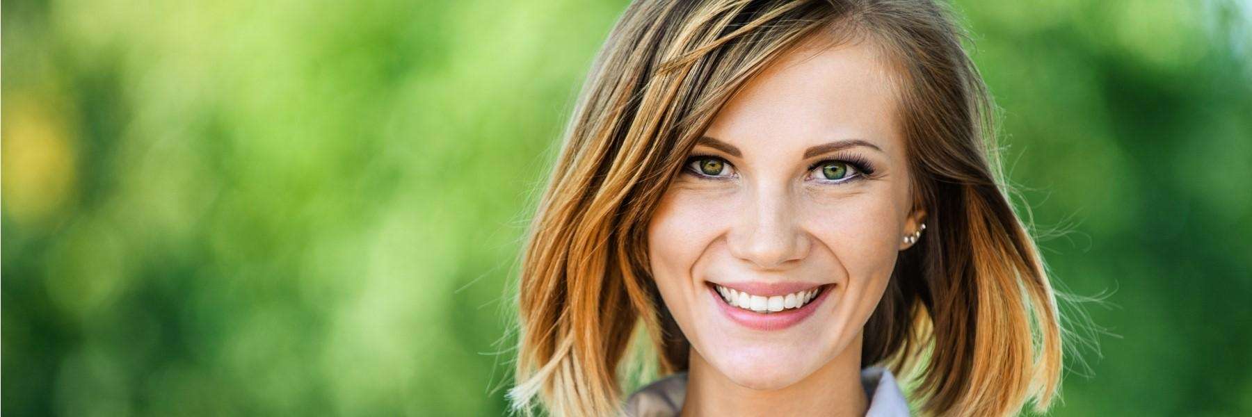 woman with short brown hair smiling | dentist new orleans la