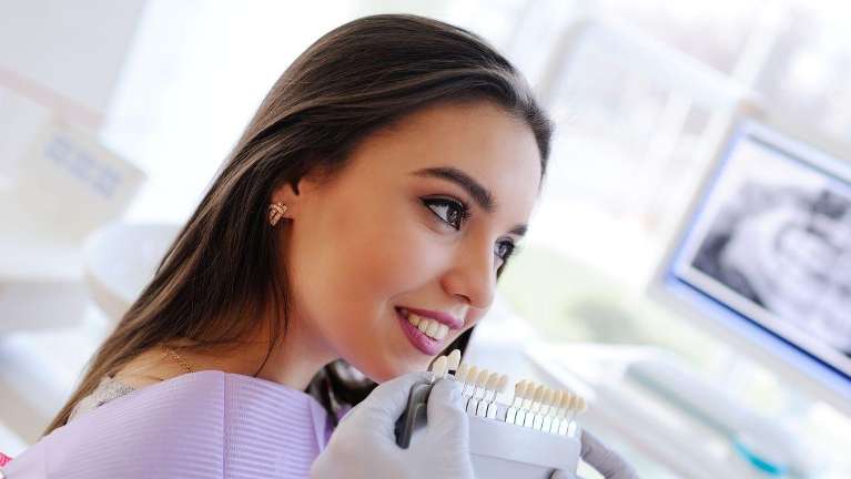 Female patient in New Orleans checking for teeth whitening result