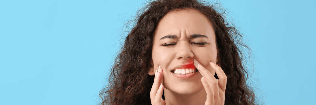 woman in pain from a gum infection in New Orleans